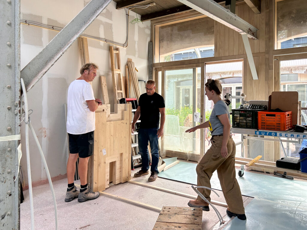 Interior walls made of reused CLT are being installed.