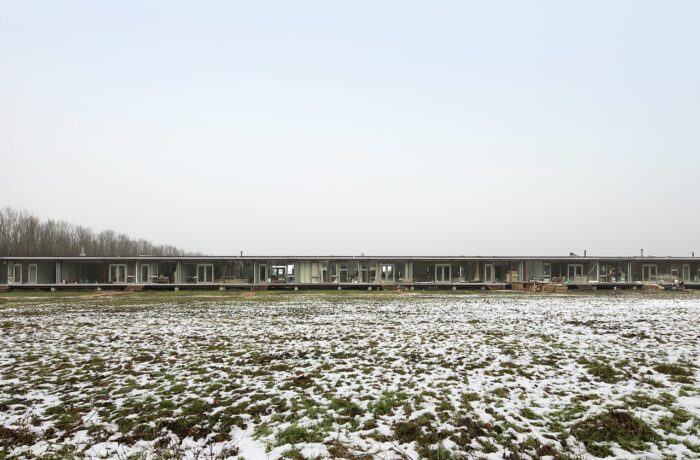 100-metre long sustainable housing with varied facades and large glass panels, co-living Oosterwold, Almere