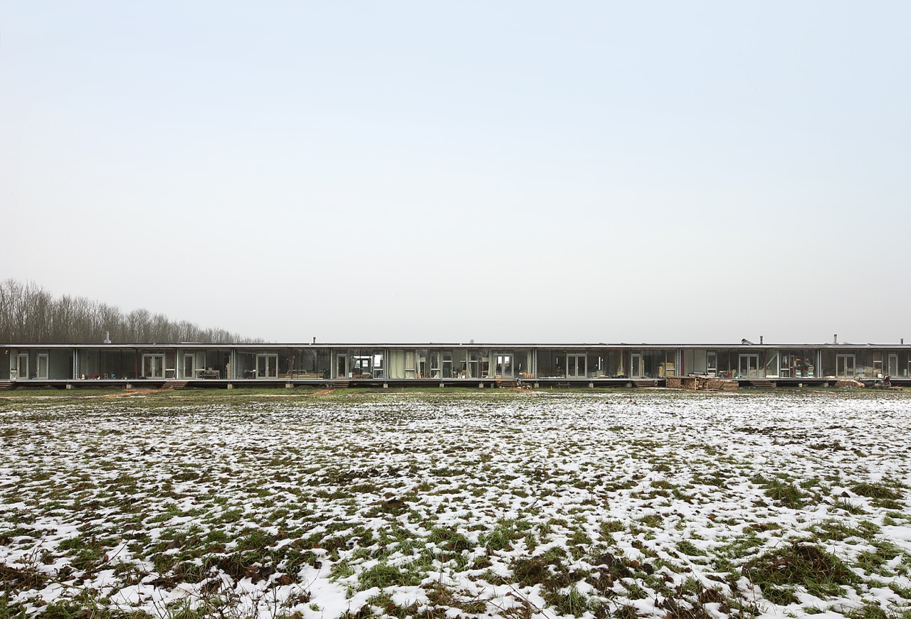 100-metre long sustainable housing with varied facades and large glass panels, co-living Oosterwold, Almere
